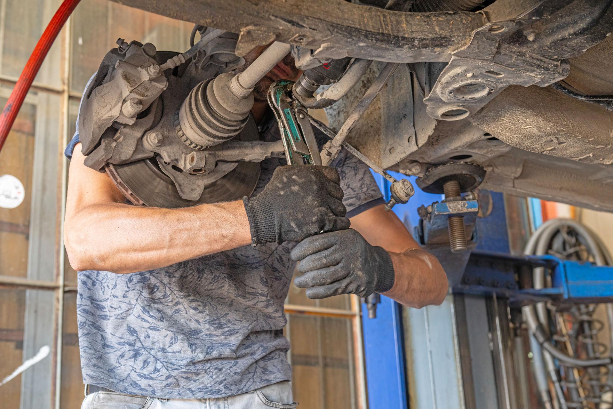 Brake repair on a vehicle lift at Vorenza Auto Repair in Derry, NH