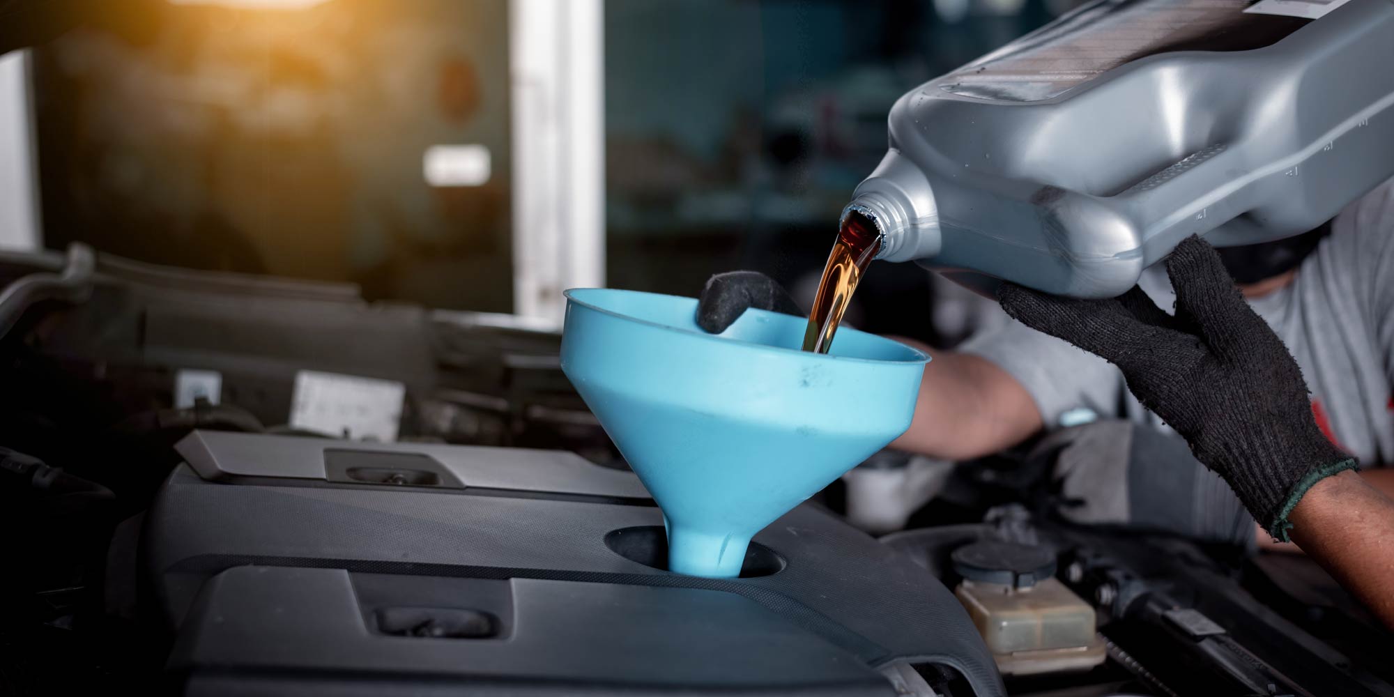 Engine oil being poured during a professional oil change