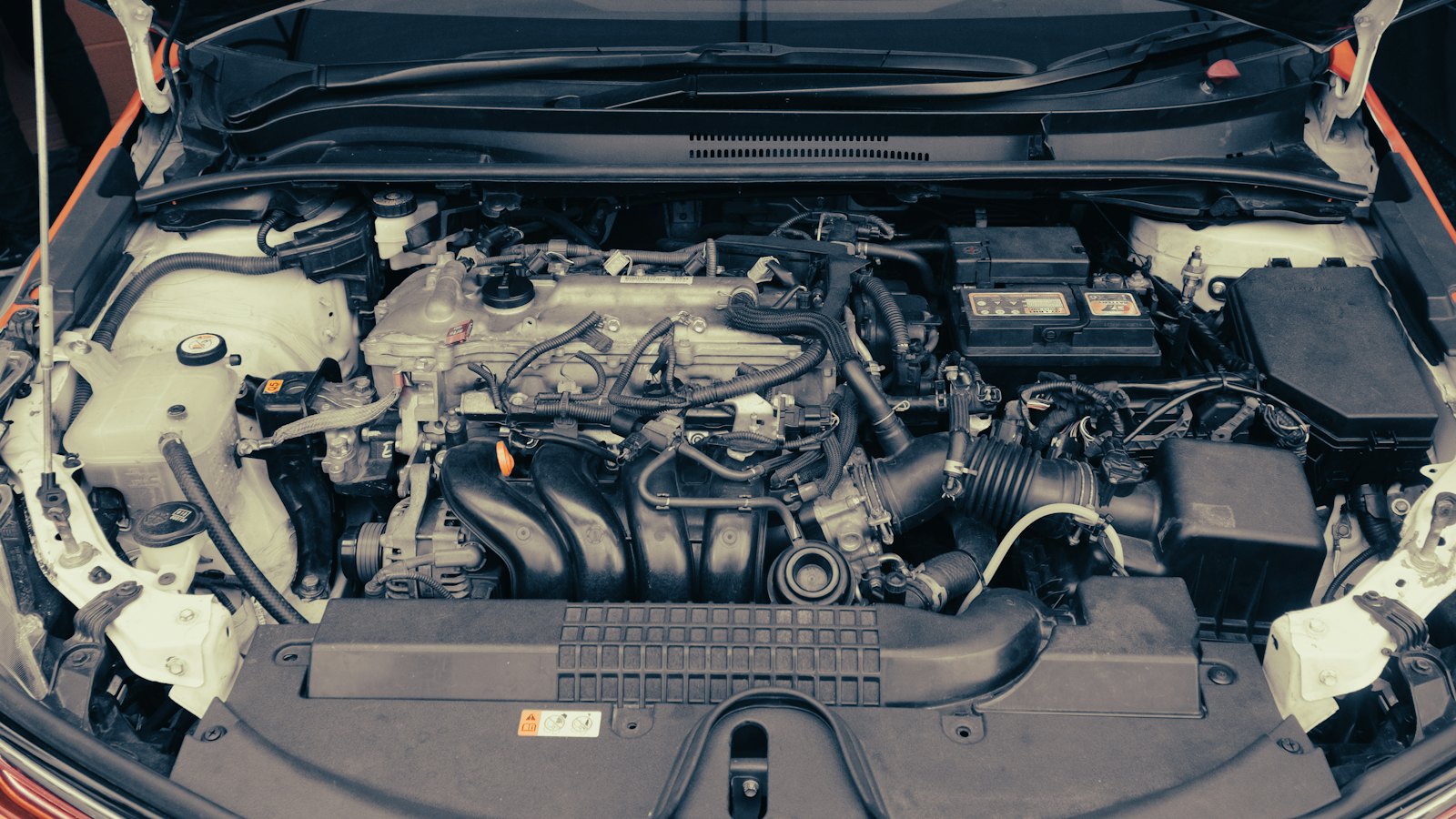 Open engine bay of a late-model commuter car with the 12-volt battery visible, ready for a battery test and car battery replacement in Derry, NH