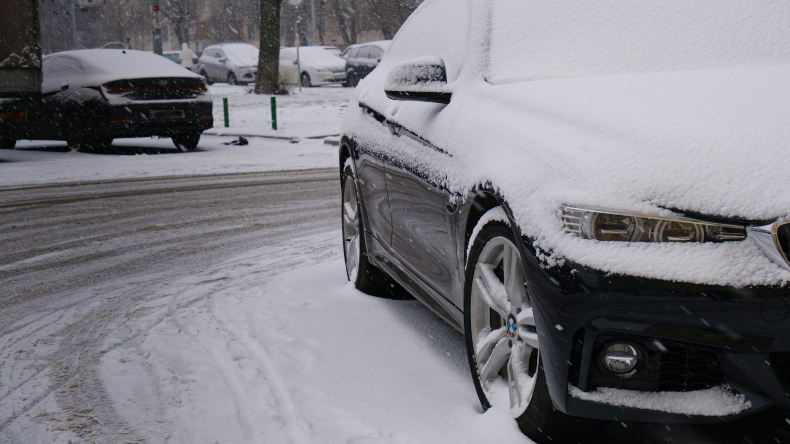 Sedan parked on a residential street under fresh snow, the kind of cold overnight that exposes a weak car battery in southern New Hampshire