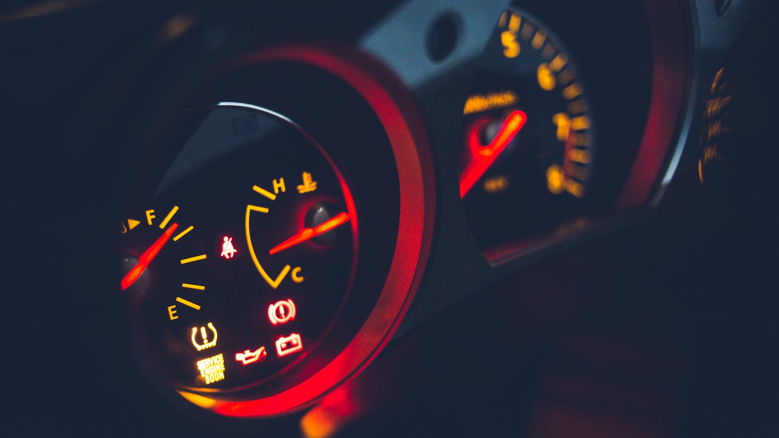 Instrument cluster with dashboard warning lights lit for tire pressure, brakes, oil pressure and the battery