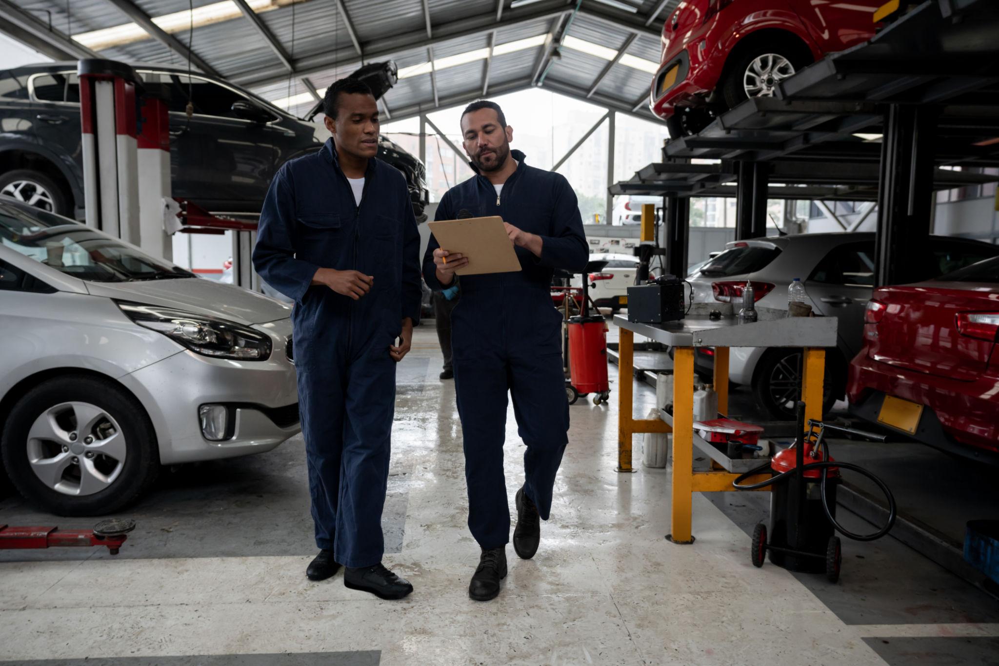 Muffler service on a vehicle lift at Vorenza Auto Repair